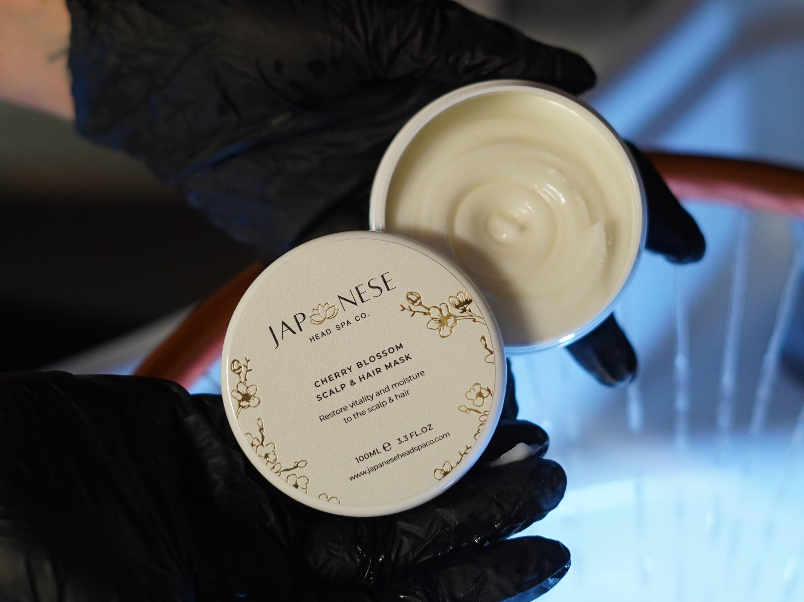 Professional therapist performing authentic Japanese Head Spa using Cherry Blossom products.