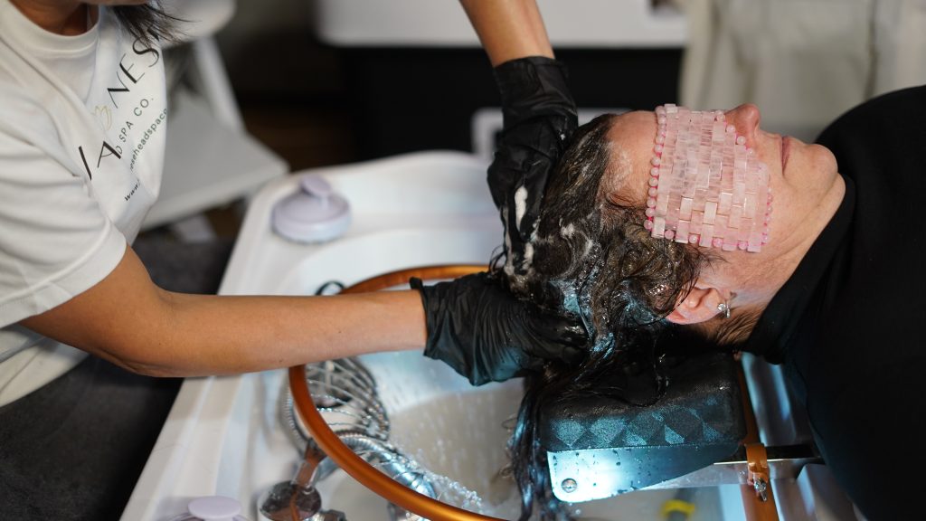 Professional therapist performing authentic Japanese Head Spa using Cherry Blossom products.